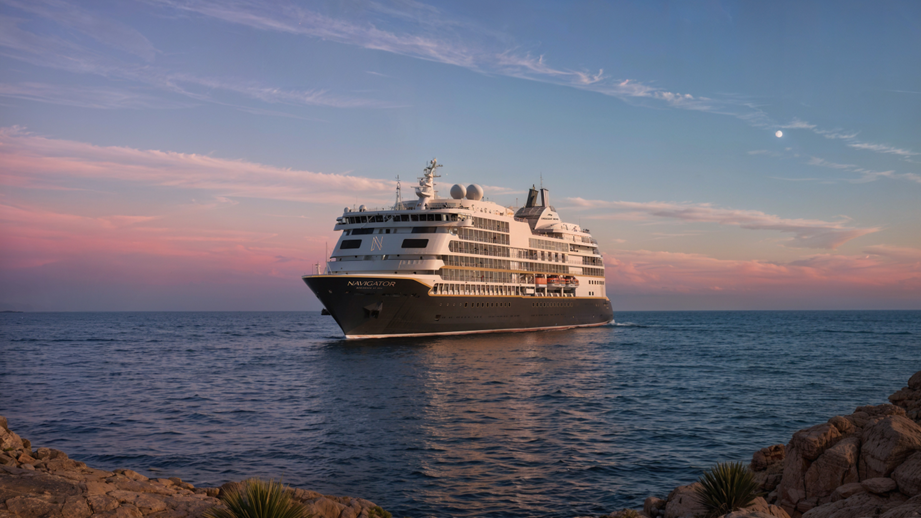 Crescent Seas Navigator luxury residential cruise ship sailing across the open ocean at sunset